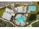 A high angle aerial view of a luxurious community pool, lawns, parking, and community center at 8273 Shooting Star Rd, Sarasota, FL 34241