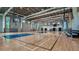 A large indoor basketball court with polished wood floor, multiple hoops, and bleacher seating at 8273 Shooting Star Rd, Sarasota, FL 34241