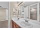 Bathroom featuring double vanity with under storage and decorative mirrors at 8273 Shooting Star Rd, Sarasota, FL 34241