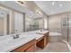 Bright bathroom featuring double vanity, soaking tub, and glass-enclosed shower at 8273 Shooting Star Rd, Sarasota, FL 34241