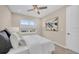 Bright bedroom featuring neutral decor, ceiling fan, and natural light at 8273 Shooting Star Rd, Sarasota, FL 34241