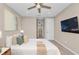 Inviting bedroom with a ceiling fan, TV, and neutral decor at 8273 Shooting Star Rd, Sarasota, FL 34241