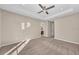 Open and spacious bedroom with neutral colored walls, carpet, a ceiling fan, and plenty of natural light at 8273 Shooting Star Rd, Sarasota, FL 34241