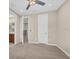 Open bedroom featuring neutral colored walls and carpet, and a ceiling fan at 8273 Shooting Star Rd, Sarasota, FL 34241