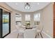 Charming breakfast nook with a round glass table and backyard view at 8273 Shooting Star Rd, Sarasota, FL 34241