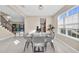 Bright dining room with modern table and chairs set, tile floors, and natural lighting at 8273 Shooting Star Rd, Sarasota, FL 34241
