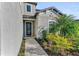 Home entryway featuring manicured landscaping with bushes and palm trees along the walkway at 8273 Shooting Star Rd, Sarasota, FL 34241