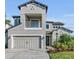 Beautiful two-story home with a gray exterior, two-car garage, small balcony, and nicely landscaped front yard at 8273 Shooting Star Rd, Sarasota, FL 34241