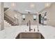 Modern kitchen showcasing a quartz countertop island, stainless steel sink, and stylish pendant lighting fixtures at 8273 Shooting Star Rd, Sarasota, FL 34241
