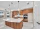 Spacious kitchen with center island, wood cabinets, modern stainless steel appliances, and granite countertops at 8273 Shooting Star Rd, Sarasota, FL 34241