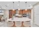 Bright, spacious kitchen with a large island, pendant lighting, stainless steel appliances, and ample seating at 8273 Shooting Star Rd, Sarasota, FL 34241
