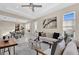 Sunlit living room featuring a cozy sofa, stylish decor, and large windows that provide ample natural light at 8273 Shooting Star Rd, Sarasota, FL 34241