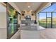Stylish outdoor kitchen with grill, granite countertop, and bar seating at 8273 Shooting Star Rd, Sarasota, FL 34241