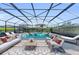 Enclosed pool with outdoor seating area and well landscaped yard at 8273 Shooting Star Rd, Sarasota, FL 34241