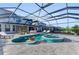 Luxurious pool and hot tub area with enclosed lanai and comfortable lounge seating at 8273 Shooting Star Rd, Sarasota, FL 34241