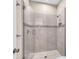 Modern tiled shower with glass door and decorative mosaic tile accent at 8273 Shooting Star Rd, Sarasota, FL 34241