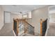 Elegant staircase with wood and iron railings, leading to the upper level of the home at 8273 Shooting Star Rd, Sarasota, FL 34241