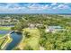 Beautiful aerial view overlooking golf course, lake, clubhouse, and landscaping at 8525 54Th Avenue E Cir, Bradenton, FL 34211