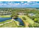 Beautiful aerial view overlooking golf course, lake, clubhouse, and landscaping at 8525 54Th Avenue E Cir, Bradenton, FL 34211