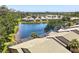 Aerial view of community homes surrounding a serene lake with mature trees and lush landscaping at 8525 54Th Avenue E Cir, Bradenton, FL 34211