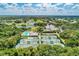 A stunning aerial view of a community featuring tennis courts and pool at 8525 54Th Avenue E Cir, Bradenton, FL 34211