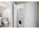 Modern bathroom with washer/dryer combo and neutral color scheme at 8525 54Th Avenue E Cir, Bradenton, FL 34211