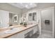 Bathroom with double sinks, ample counter space, large mirrors, and white cabinets providing comfort and convenience at 8525 54Th Avenue E Cir, Bradenton, FL 34211