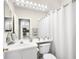 Bright bathroom with a shower, white vanity, and decorative mirror lighting at 8525 54Th Avenue E Cir, Bradenton, FL 34211