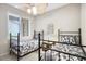 Twin bedroom featuring two twin beds, a ceiling fan, and a window providing ample natural light at 8525 54Th Avenue E Cir, Bradenton, FL 34211