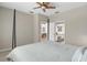 Bright bedroom showcasing a four-poster bed, ceiling fan, and en-suite bathroom with an open doorway at 8525 54Th Avenue E Cir, Bradenton, FL 34211