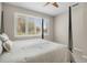 Inviting bedroom with a canopy bed and a serene view from the large window with plantation shutters at 8525 54Th Avenue E Cir, Bradenton, FL 34211