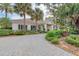 Exterior of the clubhouse with a walkway and lush landscaping at 8525 54Th Avenue E Cir, Bradenton, FL 34211