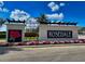 An attractive community sign with beautiful landscaping and blue skies at 8525 54Th Avenue E Cir, Bradenton, FL 34211