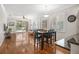 The dining area is open to the living room and features wood floors and plantation shutters at 8525 54Th Avenue E Cir, Bradenton, FL 34211