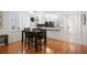 An open dining area has wood floors with a view of the kitchen at 8525 54Th Avenue E Cir, Bradenton, FL 34211