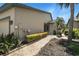 Home exterior showing lush landscaping along the walkway, leading to the front entrance and a cozy garden at 8525 54Th Avenue E Cir, Bradenton, FL 34211