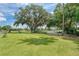 Scenic golf course showcasing manicured greens, towering trees draped with moss, and distant glimpses of water at 8525 54Th Avenue E Cir, Bradenton, FL 34211