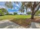 View of the golf course from a shaded patio with a tree in the foreground at 8525 54Th Avenue E Cir, Bradenton, FL 34211