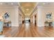 Elegant hallway with decorative ceilings, artwork, and wood floors at 8525 54Th Avenue E Cir, Bradenton, FL 34211