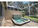 Screened lanai with integrated waterfall hot tub and privacy wall with lush surrounding landscaping at 8525 54Th Avenue E Cir, Bradenton, FL 34211