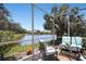 Screened lanai with peaceful water views and seating arrangement perfect for relaxing at 8525 54Th Avenue E Cir, Bradenton, FL 34211