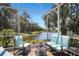 Screened lanai with comfortable seating overlooking a tranquil lake and lush greenery at 8525 54Th Avenue E Cir, Bradenton, FL 34211