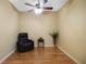Cozy living room area features wood floors and a black recliner at 8525 54Th Avenue E Cir, Bradenton, FL 34211