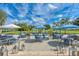 Spacious outdoor patio seating area with blue umbrellas and hanging market lights at 8525 54Th Avenue E Cir, Bradenton, FL 34211