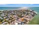 Breathtaking aerial view of beachfront community and beautiful beach with sparkling ocean views at 880 N Shore Dr, Anna Maria, FL 34216