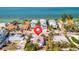Beach house located near white sandy beaches and turquoise waters, surrounded by lush palm trees and beautiful scenery at 880 N Shore Dr, Anna Maria, FL 34216