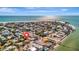 Stunning aerial view of a coastal community with beachfront homes and sparkling ocean views on a sunny day at 880 N Shore Dr, Anna Maria, FL 34216