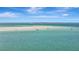 Stunning aerial view capturing the clear turquoise waters and a distant island at 880 N Shore Dr, Anna Maria, FL 34216