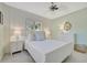 Bedroom with a white bed, bright light, and mint-painted accent wall, creating a serene ambiance at 880 N Shore Dr, Anna Maria, FL 34216