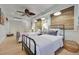 Bedroom featuring two twin beds, shiplap walls, hard wood flooring and light-filtering window shades at 880 N Shore Dr, Anna Maria, FL 34216